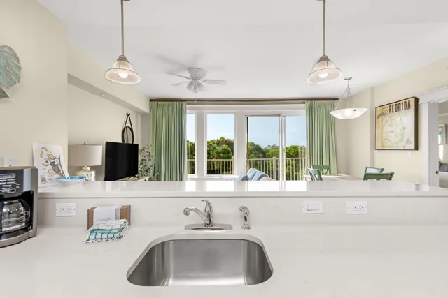 a living room with stainless steel appliances kitchen island granite countertop furniture and a view of kitchen