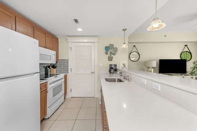 a kitchen with a refrigerator and a sink