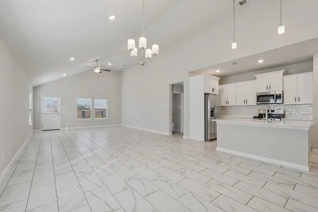 a view of a house with a yard and lake view