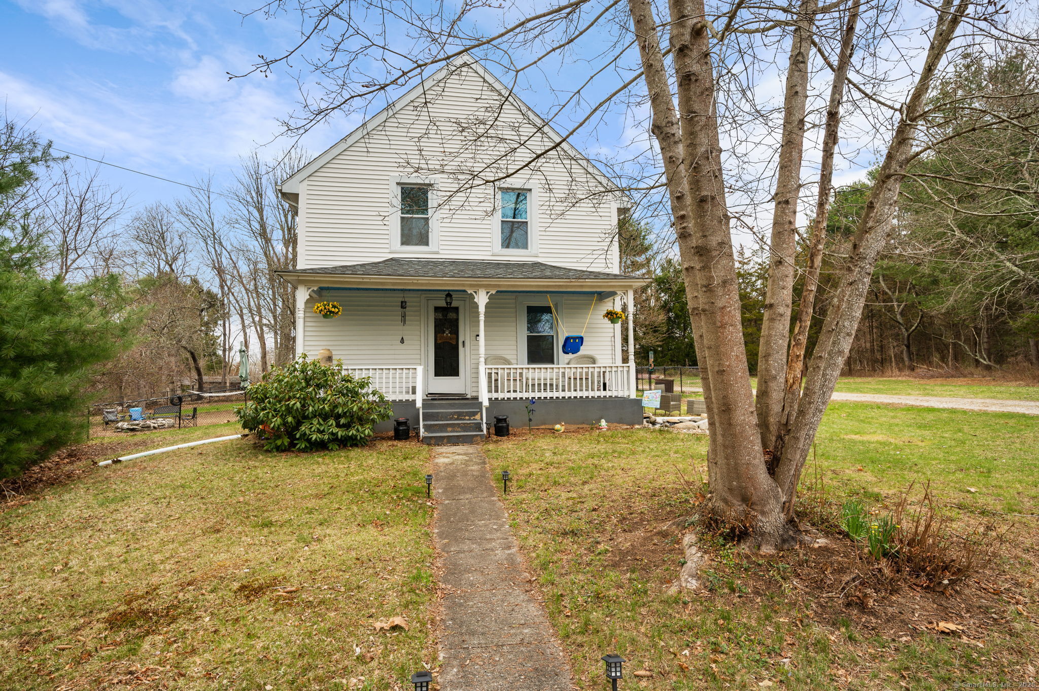 a view of a house with backyard and sitting area