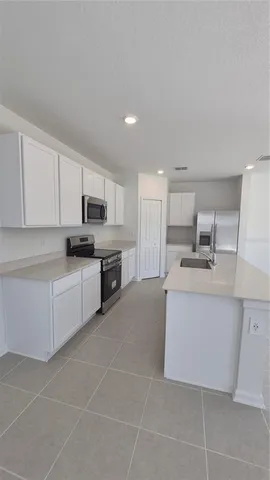 a room with wooden cabinets and a sink