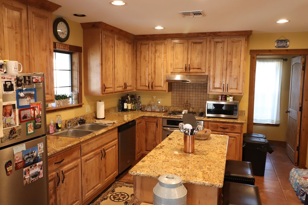 5-6 SD 45125 Rocksprings, TX 78880 - Photo 20 of 28 a kitchen with wooden cabinets and sink