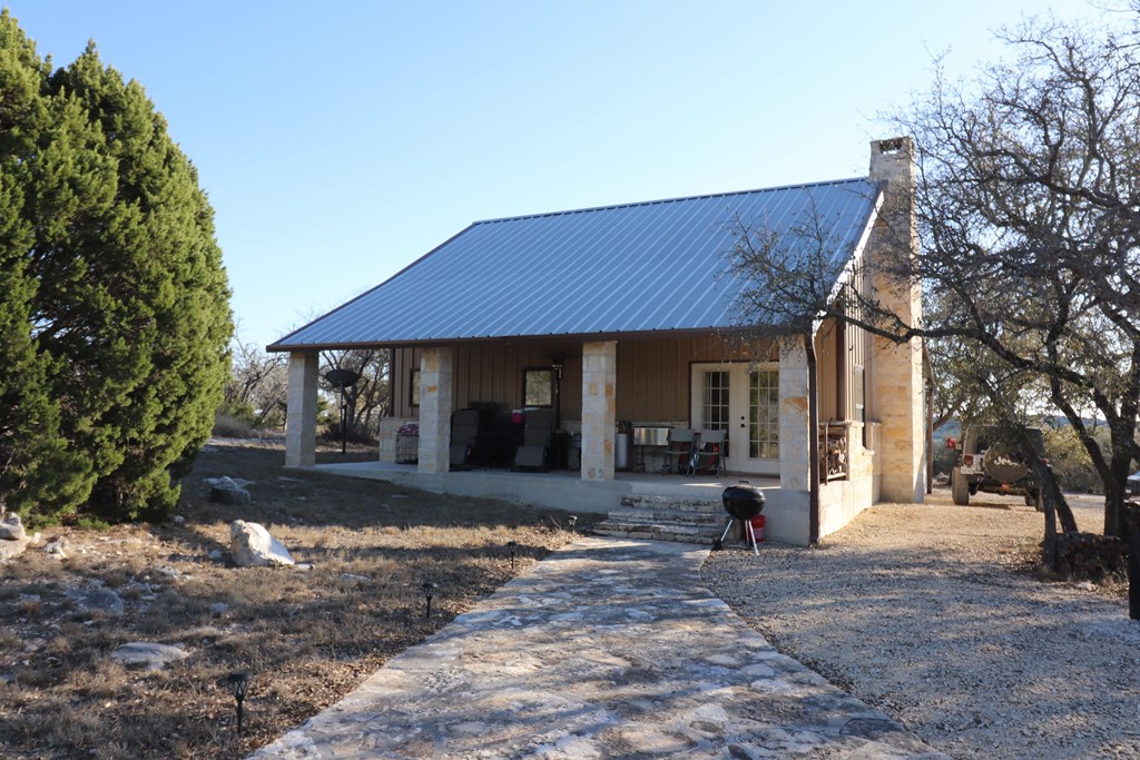 5-6 SD 45125 Rocksprings, TX 78880 - Photo 28 of 28 a front view of a house with a yard and tree s