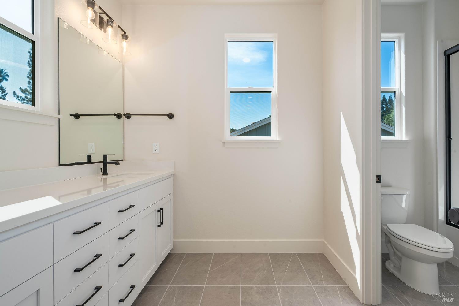 3461 Ruston Lane Napa, CA 94558 - Photo 15 of 22 a bathroom with a granite countertop sink a toilet and a mirror