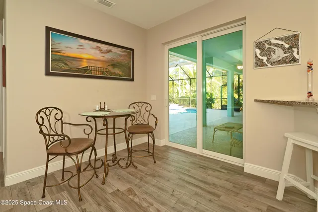 a bathroom with a granite countertop sink a mirror and shower
