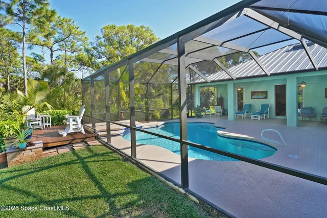 a view of a patio with chairs and potted plants