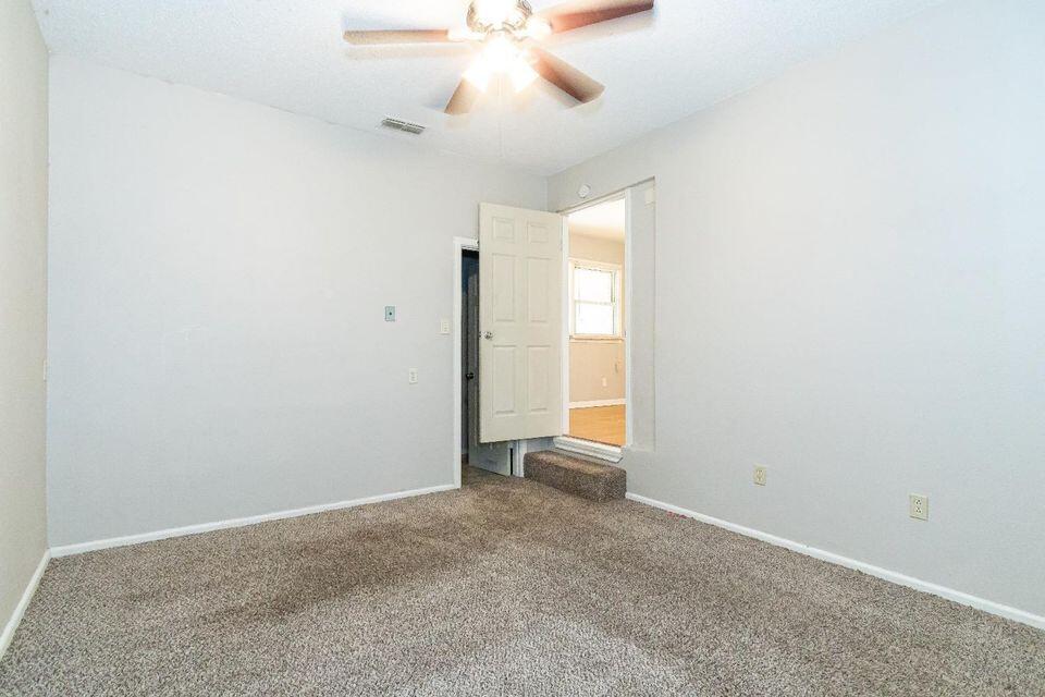 4212 42nd Street Lubbock, TX 79413 - Photo 12 of 18 an empty room with a ceiling fan and carpet