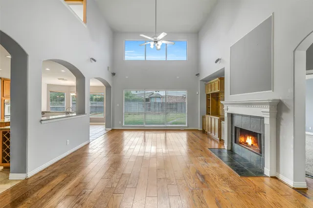 a living room with furniture a fireplace and a large mirror