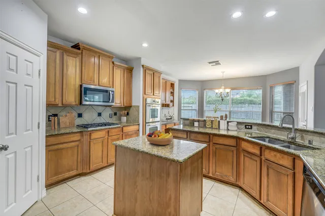 a bathroom with a sink a large mirror and a bathtub