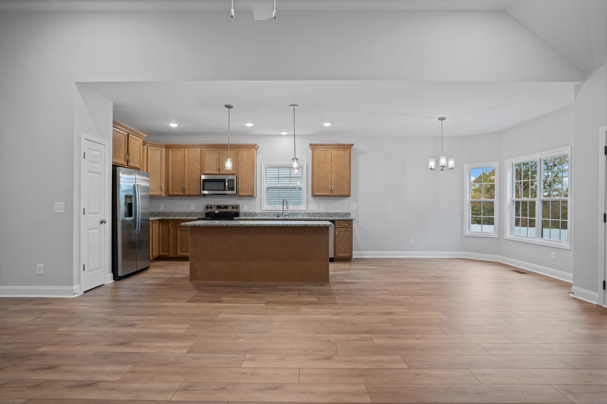 26 Cornerstone Reserves Clarksville, TN 37040 - Photo 12 of 28 a large kitchen with kitchen island a sink wooden floor and stainless steel appliances