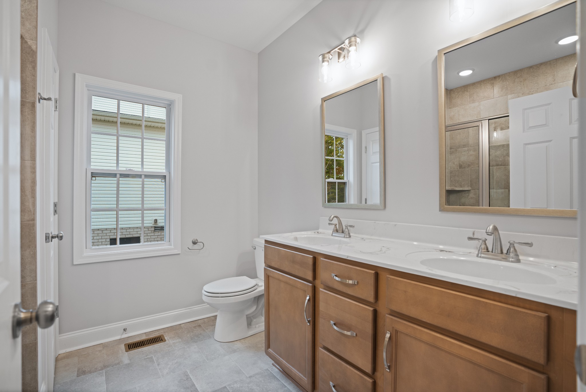 26 Cornerstone Reserves Clarksville, TN 37040 - Photo 16 of 28 a bathroom with a granite countertop toilet a sink a mirror and a window