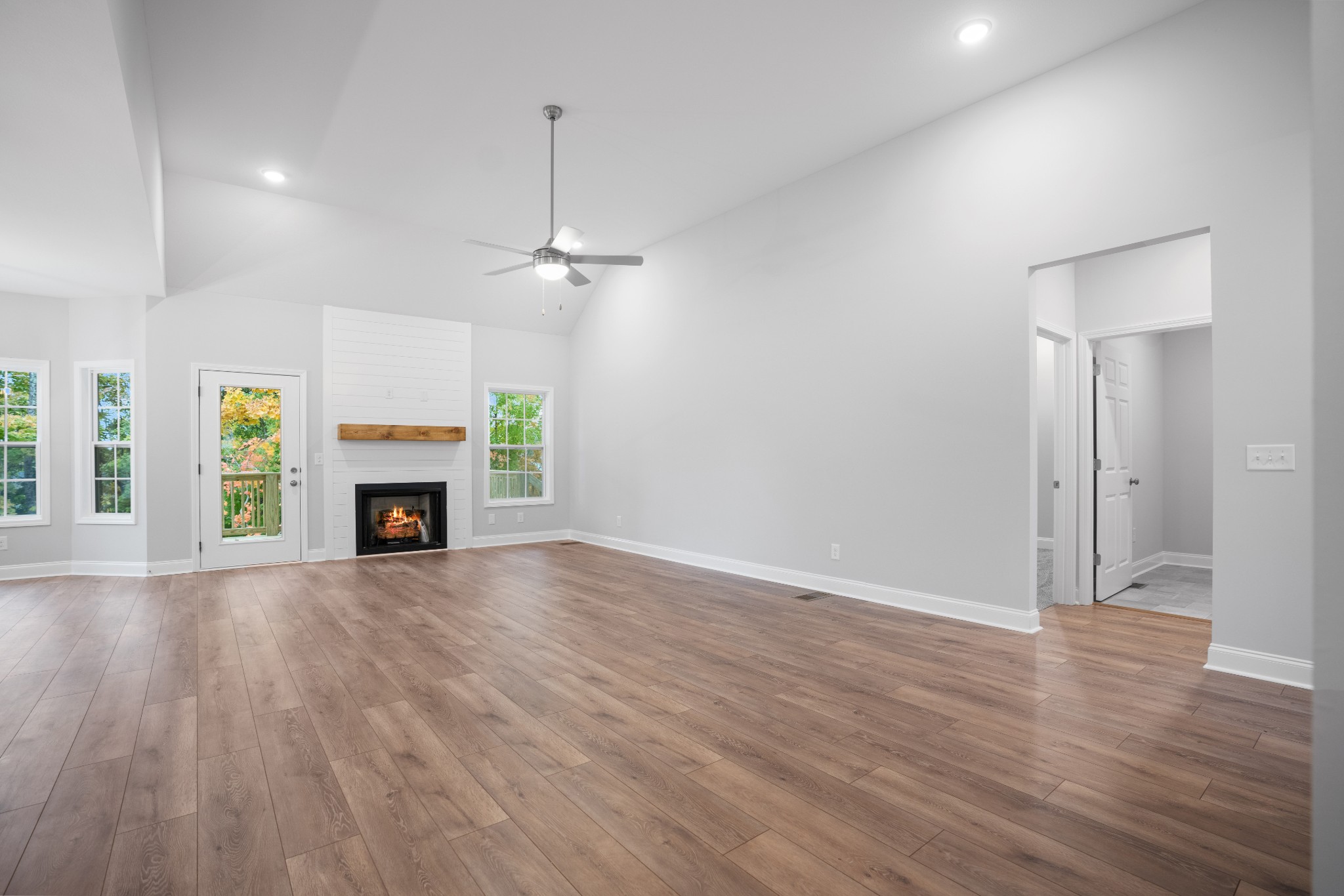 26 Cornerstone Reserves Clarksville, TN 37040 - Photo 4 of 28 an empty room with wooden floor fireplace and windows