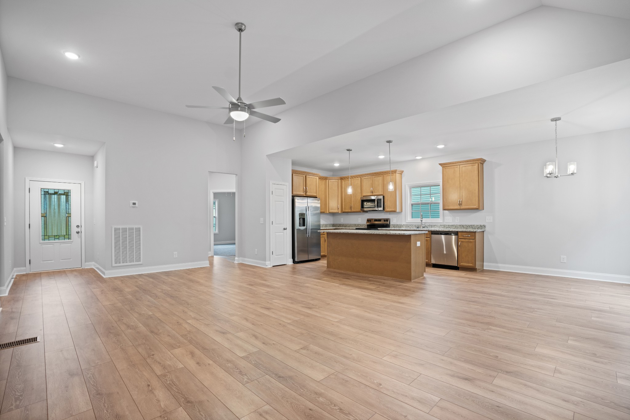 26 Cornerstone Reserves Clarksville, TN 37040 - Photo 5 of 28 a view of kitchen with kitchen island a sink wooden floor and a refrigerator