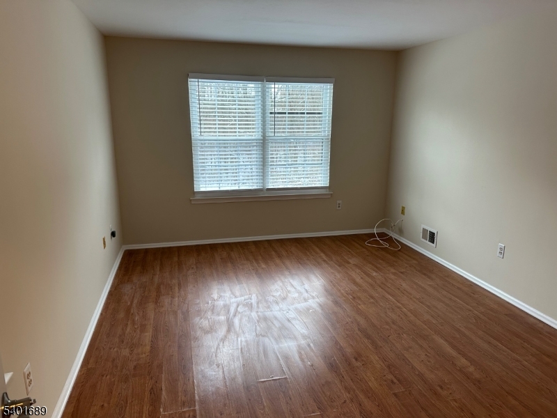 236 Irving Place Basking Ridge, NJ 07920 - Photo 12 of 18 an empty room with wooden floor and windows