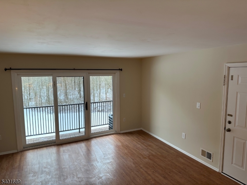 236 Irving Place Basking Ridge, NJ 07920 - Photo 3 of 18 an empty room with wooden floor and windows