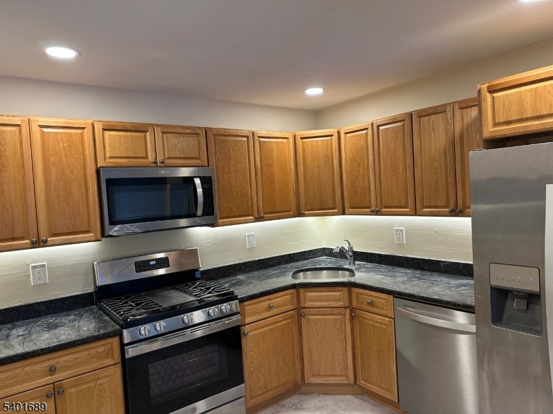 236 Irving Place Basking Ridge, NJ 07920 - Photo 4 of 18 a kitchen with granite countertop a sink stainless steel appliances and cabinets