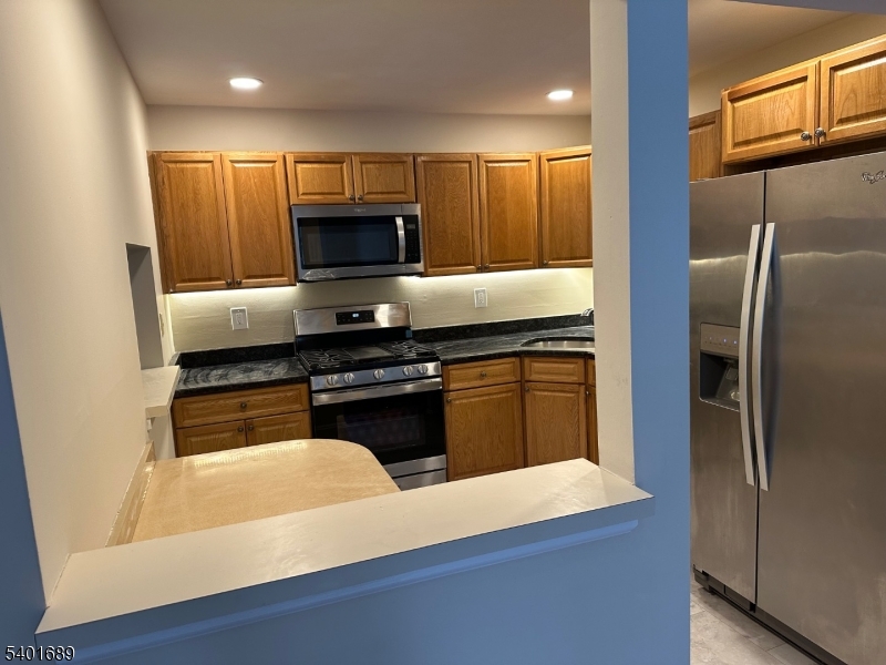 236 Irving Place Basking Ridge, NJ 07920 - Photo 5 of 18 a kitchen with granite countertop a refrigerator and a stove
