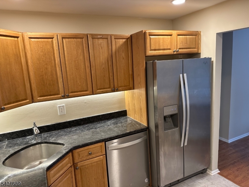 236 Irving Place Basking Ridge, NJ 07920 - Photo 6 of 18 a kitchen with granite countertop a refrigerator and a sink