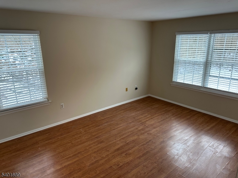 236 Irving Place Basking Ridge, NJ 07920 - Photo 9 of 18 a view of an empty room with wooden floor and a window