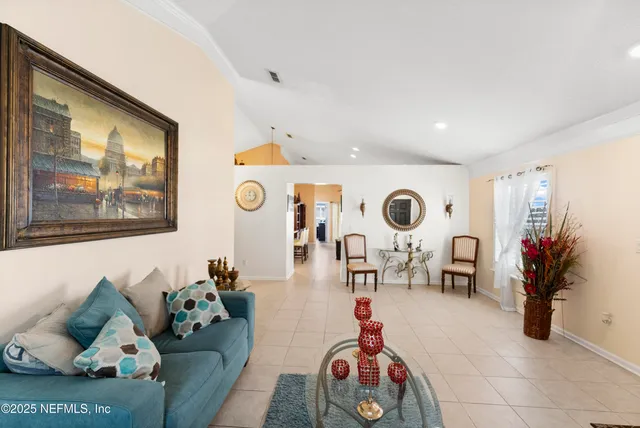 a living room with furniture and flowers