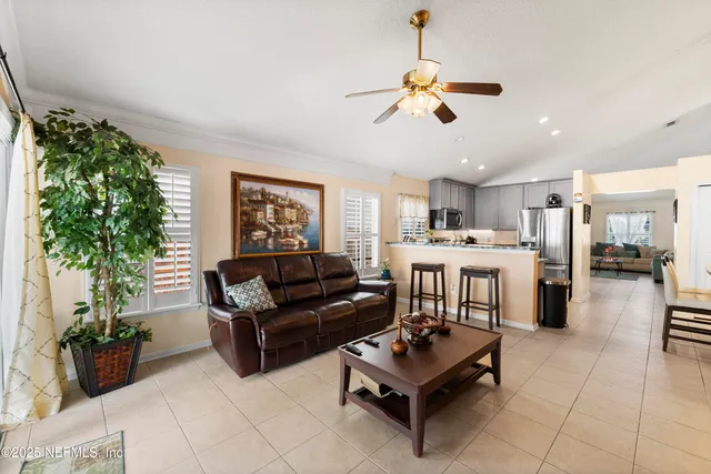a living room with furniture and a potted plant