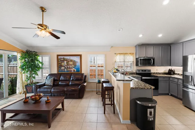 a kitchen with a refrigerator and a stove top oven