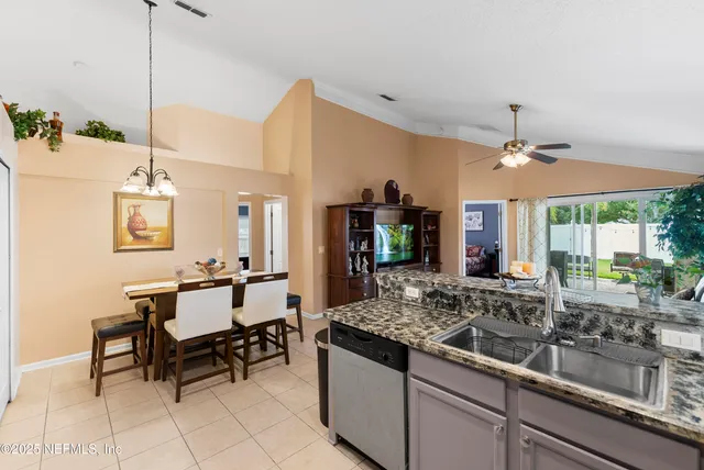 a kitchen with sink and view of living room
