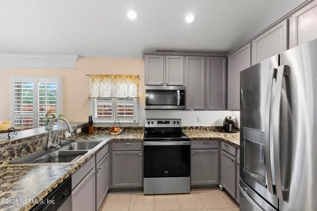 a kitchen with a sink stove and refrigerator