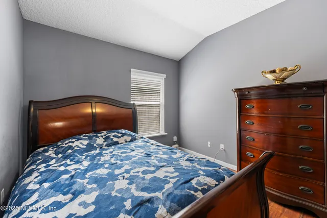 a bedroom with a bed and a dresser