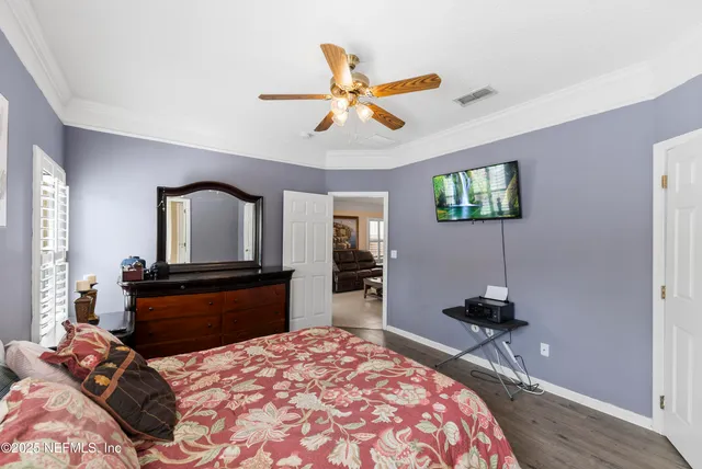 a bedroom with a bed and a chandelier
