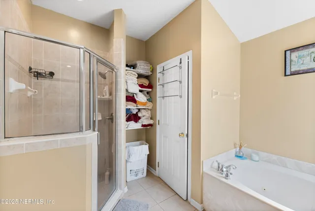 a bathroom with a bathtub and a shower