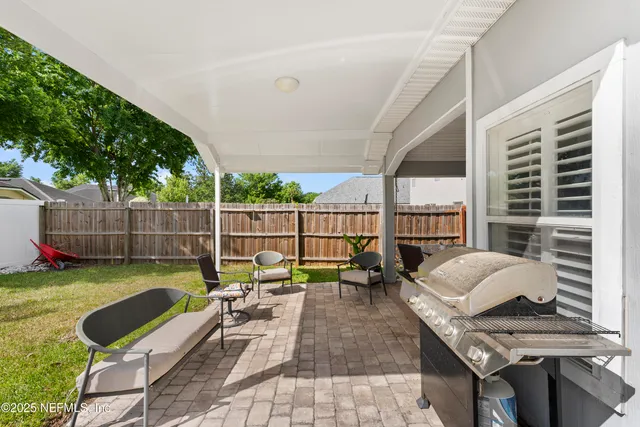 a view of a patio with couches chairs and a potted plant