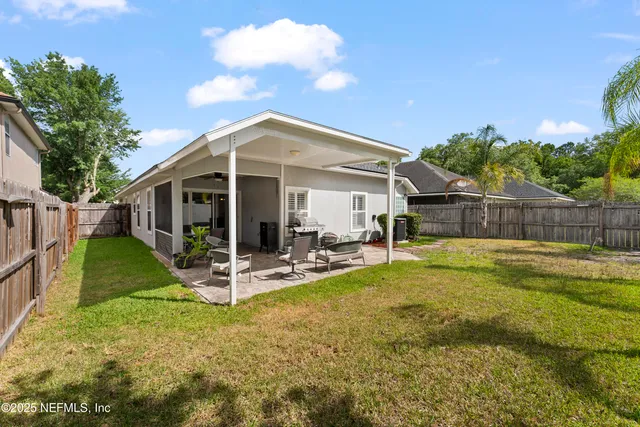 a view of a house with backyard porch and sitting area