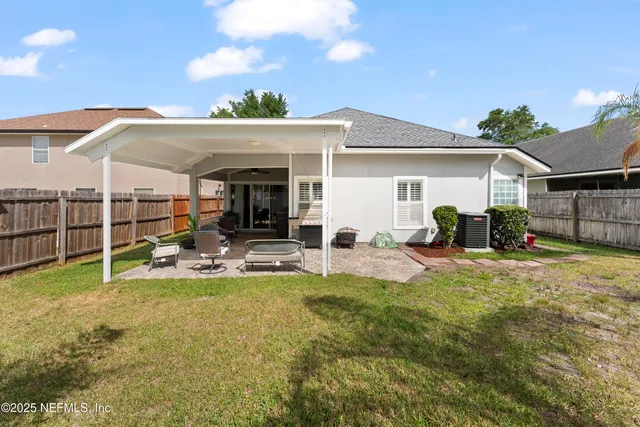 a view of a house with furniture and garden