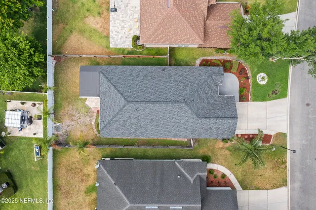 an aerial view of a house with a yard
