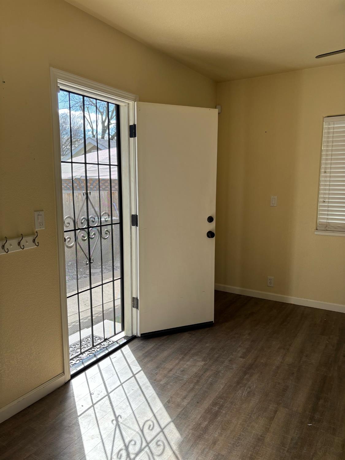 417 Enslen Avenue Modesto, CA 95354 - Photo 20 of 24 an empty room with wooden floor and windows