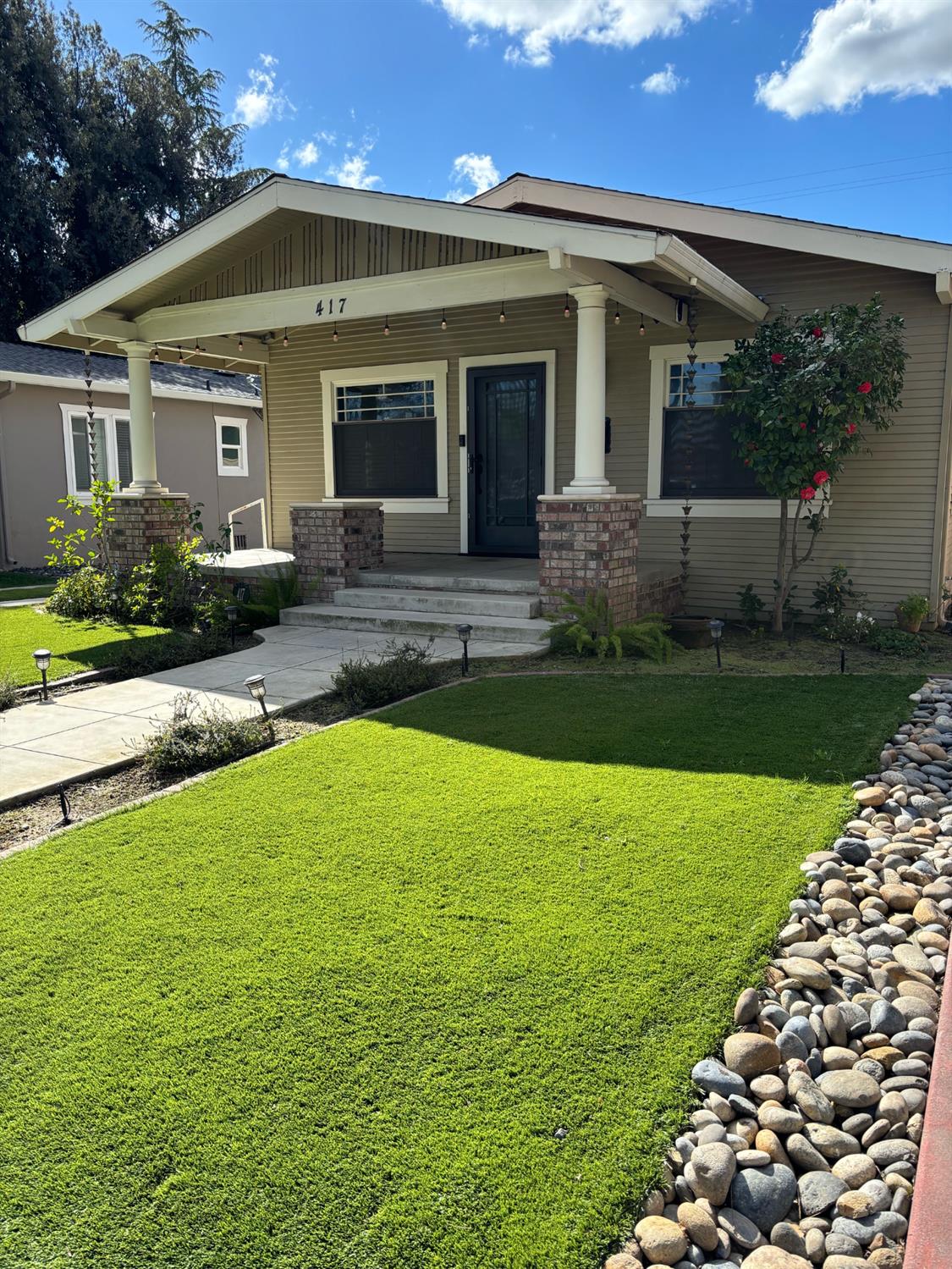 417 Enslen Avenue Modesto, CA 95354 - Photo 2 of 24 a front view of a house with garden