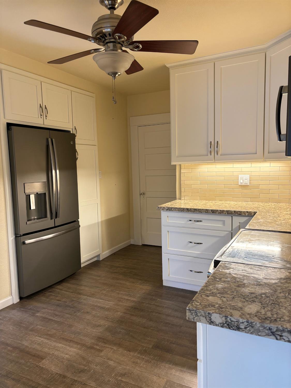 417 Enslen Avenue Modesto, CA 95354 - Photo 10 of 24 a kitchen with stainless steel appliances granite countertop a refrigerator and a stove