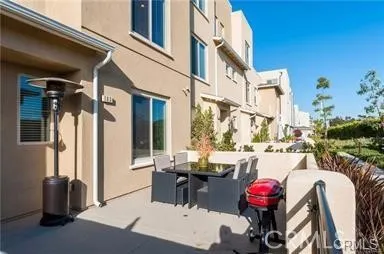 a view of a chairs and table in a balcony