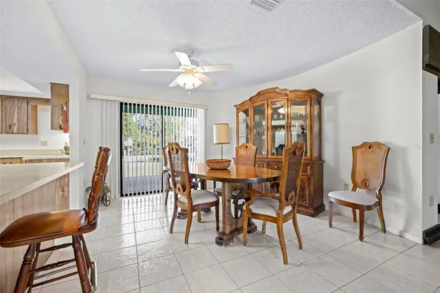 a open kitchen with stainless steel appliances granite countertop a sink and dining table chair