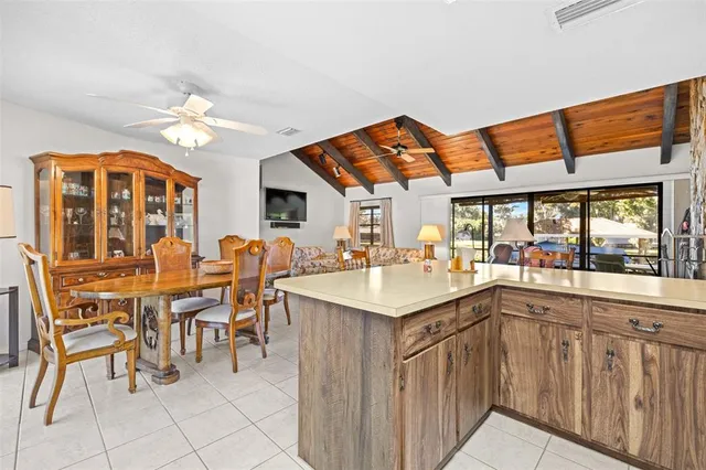 a bathroom with a granite countertop sink a toilet a mirror and shower