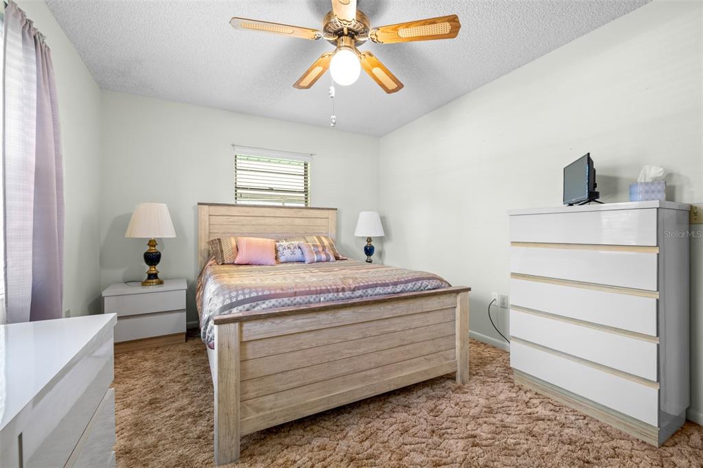 623 Racoon Lane Lorida, FL 33857 - Photo 26 of 80 a bedroom with a bed and a chandelier