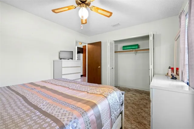 a view of a bedroom with furniture and a window