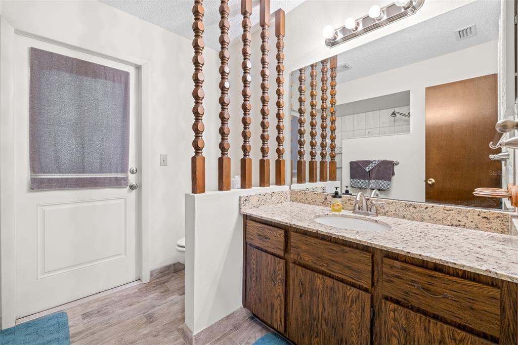 623 Racoon Lane Lorida, FL 33857 - Photo 28 of 80 a bathroom with a granite countertop sink and a mirror