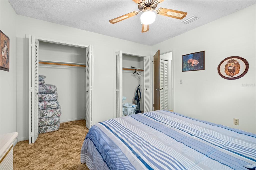 623 Racoon Lane Lorida, FL 33857 - Photo 32 of 80 a bedroom with a bed and a chandelier