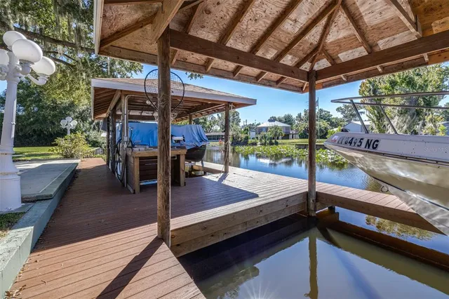 an aerial view of a house with a yard and lake view