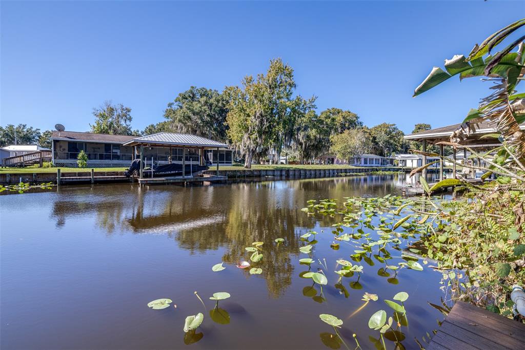 623 Racoon Lane Lorida, FL 33857 - Photo 51 of 80 a view of a lake with a table and chairs
