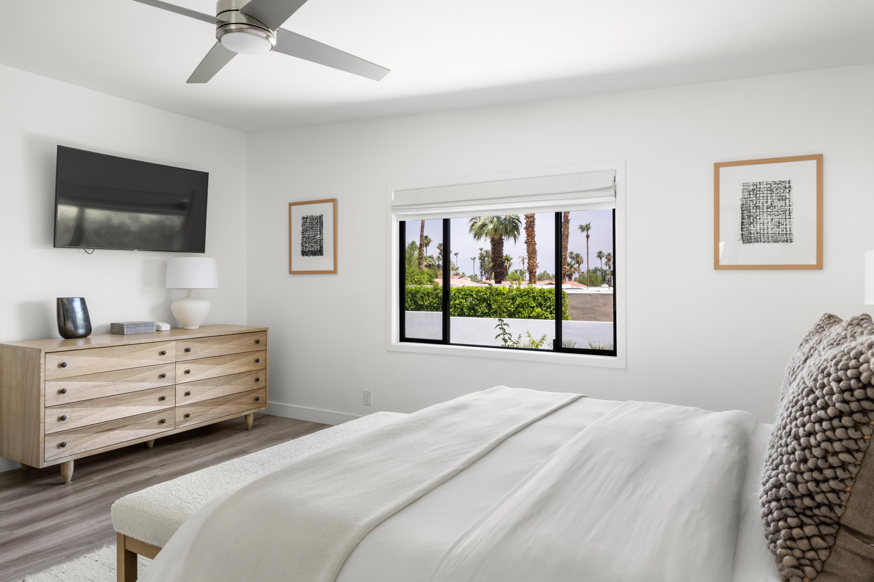 72870 Bel Air Road, Unit 3 Palm Desert, CA 92260 - Photo 14 of 36 a bedroom with a bed and a flat screen tv