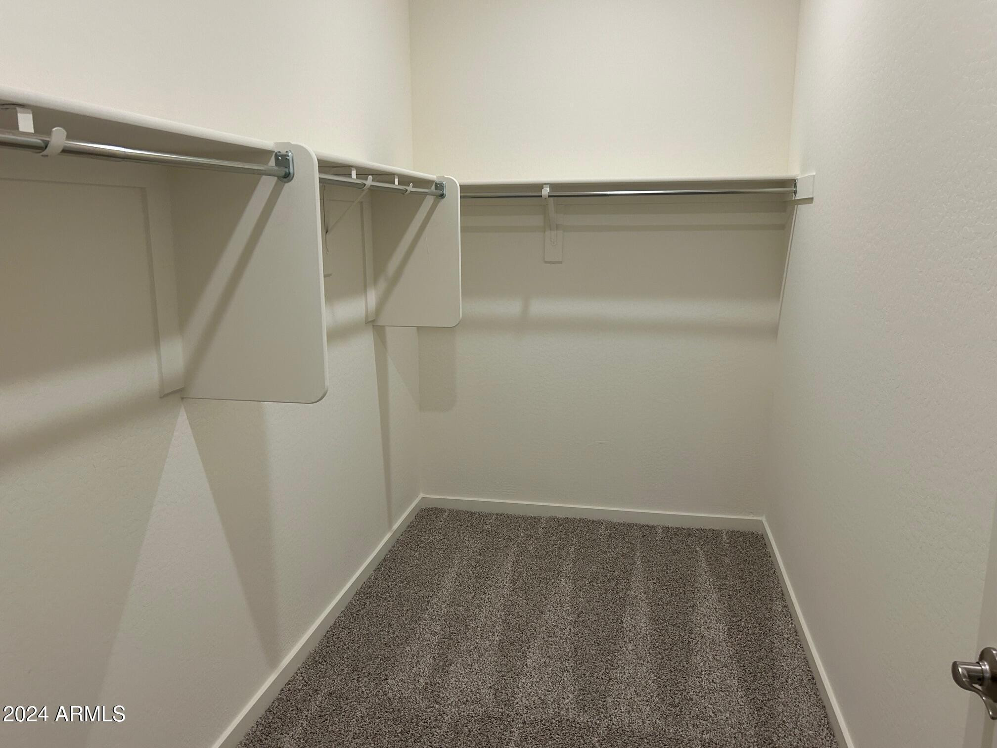 20520 North Candlelight Road Maricopa, AZ 85138 - Photo 16 of 18 a view of walk in closet with empty racks