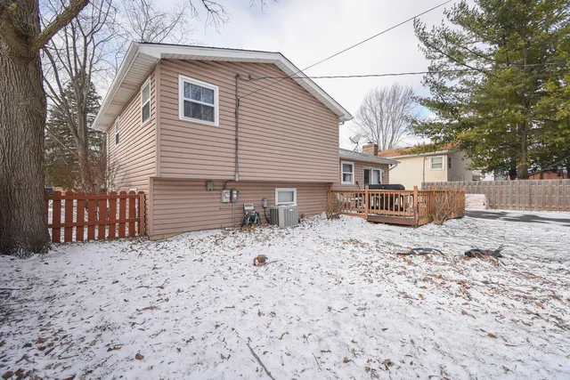 a view of a house with a yard and snow